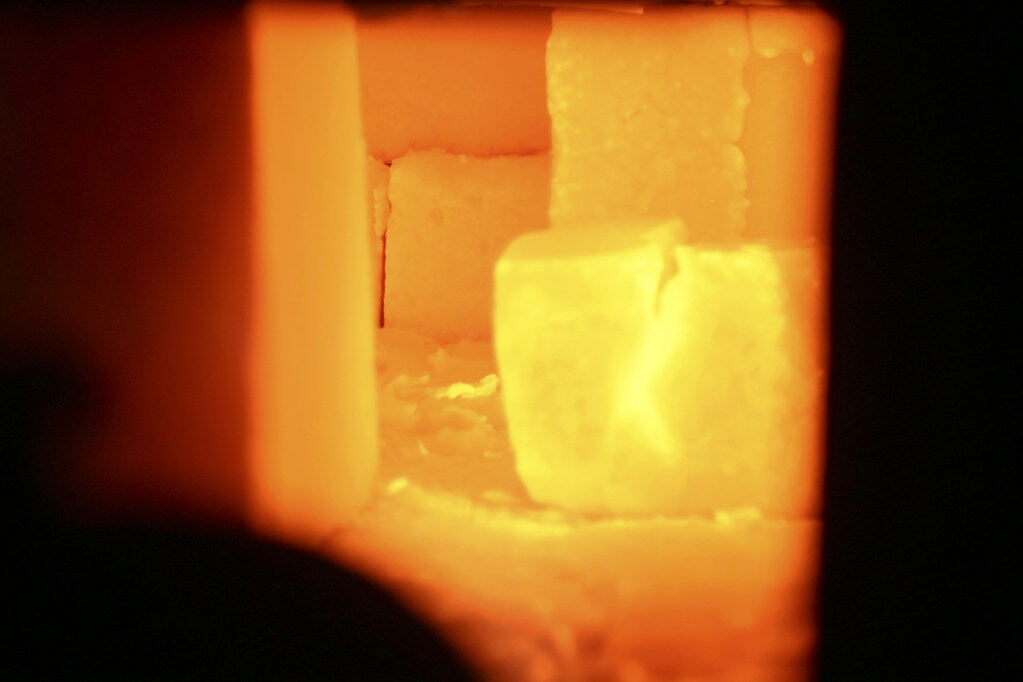 Inside a kiln at full heat: bricks glowing orange and white.